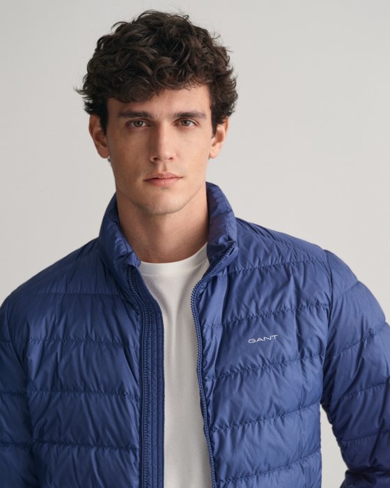 Gant blue puffer jacket on model unzipped