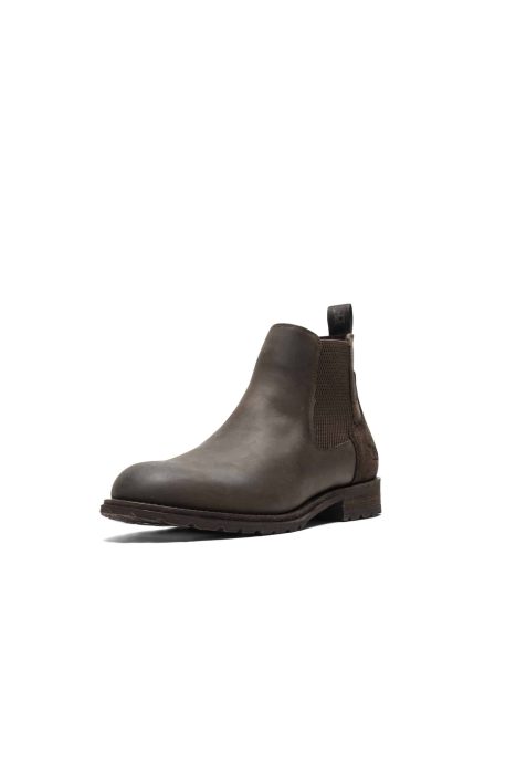 A single brown leather Chelsea boot with a pull tab at the back and elastic side panels, shown on a white background. The boot has a textured sole and a classic, sleek design.