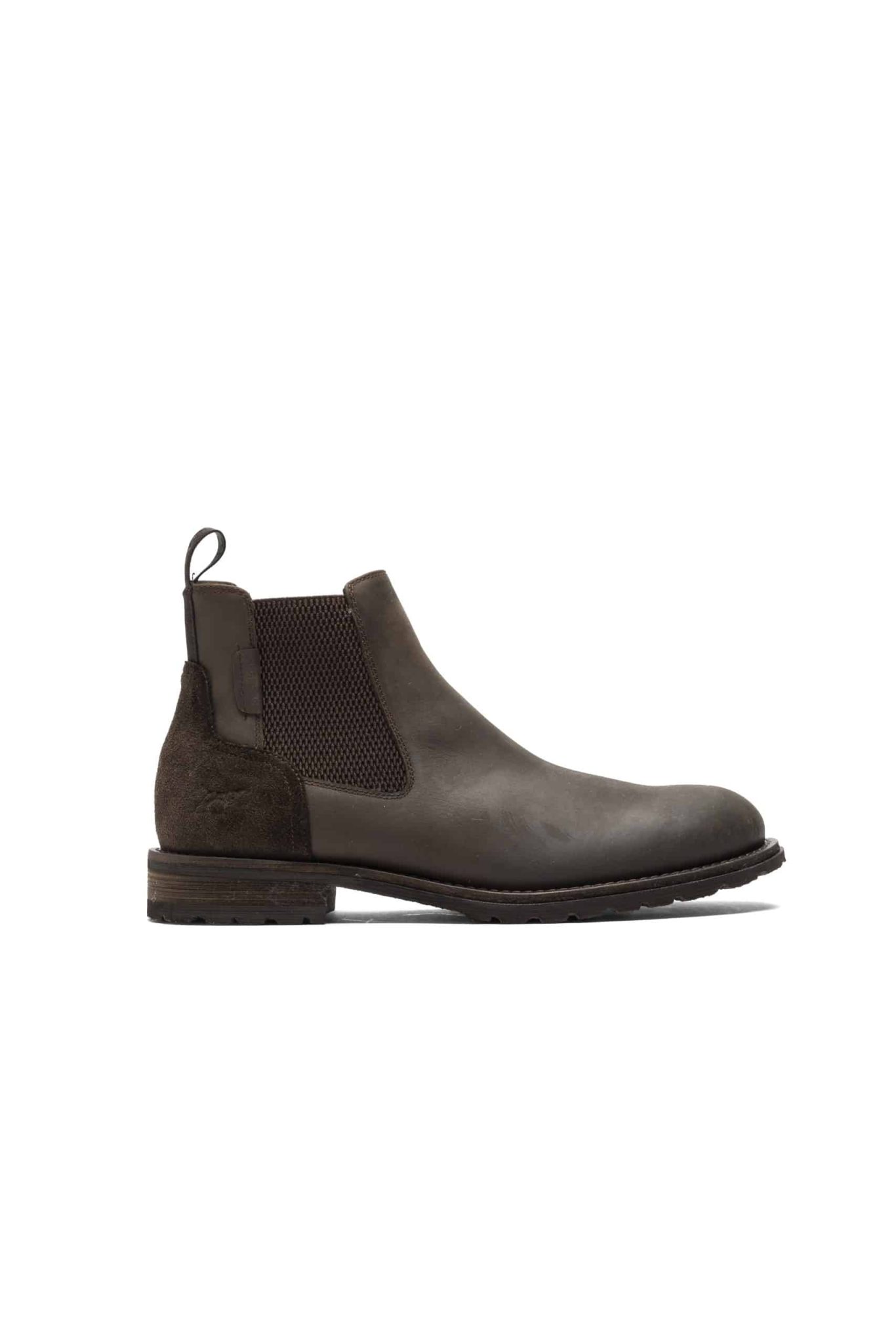 A brown leather Chelsea boot with a suede accent on the heel and elastic side panels. The boot has a pull tab and a chunky sole, and its shown against a white background.