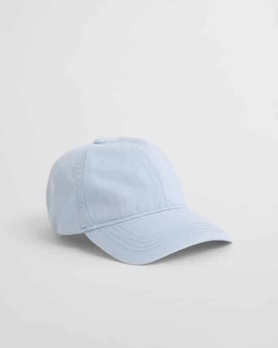 Light blue baseball cap with a curved brim and visible stitching, placed on a plain white background.