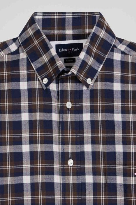 A neatly folded plaid shirt featuring a pattern of blue, brown, and white squares. The shirt has a button-down collar and visible white buttons, labeled Eden Park at the neckline.