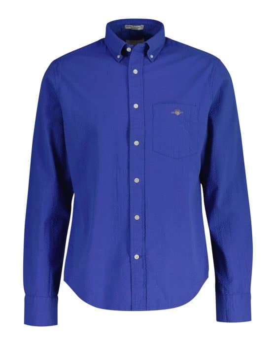Blue button-up dress shirt with a collar and front pocket. The shirt has long sleeves and visible buttons down the front.