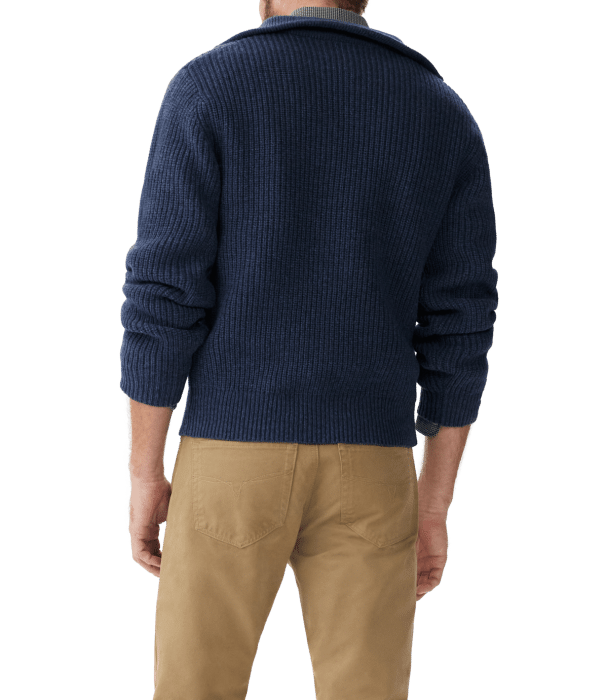 A person is shown from the back wearing a dark blue, ribbed sweater and tan pants. Their arms are relaxed by their sides and the background is transparent.