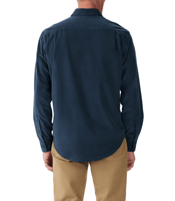 A person wearing a long-sleeve navy blue shirt and khaki pants is shown from the back, standing against a plain background.
