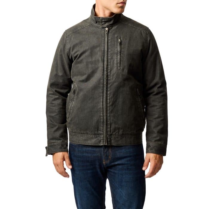 A man wearing a dark gray casual jacket with a stand collar, zippered chest pocket, and blue jeans, standing against a plain white background.