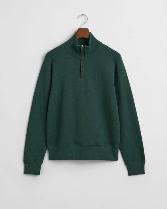A dark green quarter-zip pullover with a stand-up collar, long sleeves, ribbed cuffs, and hem, displayed on a hanger against a plain white background.