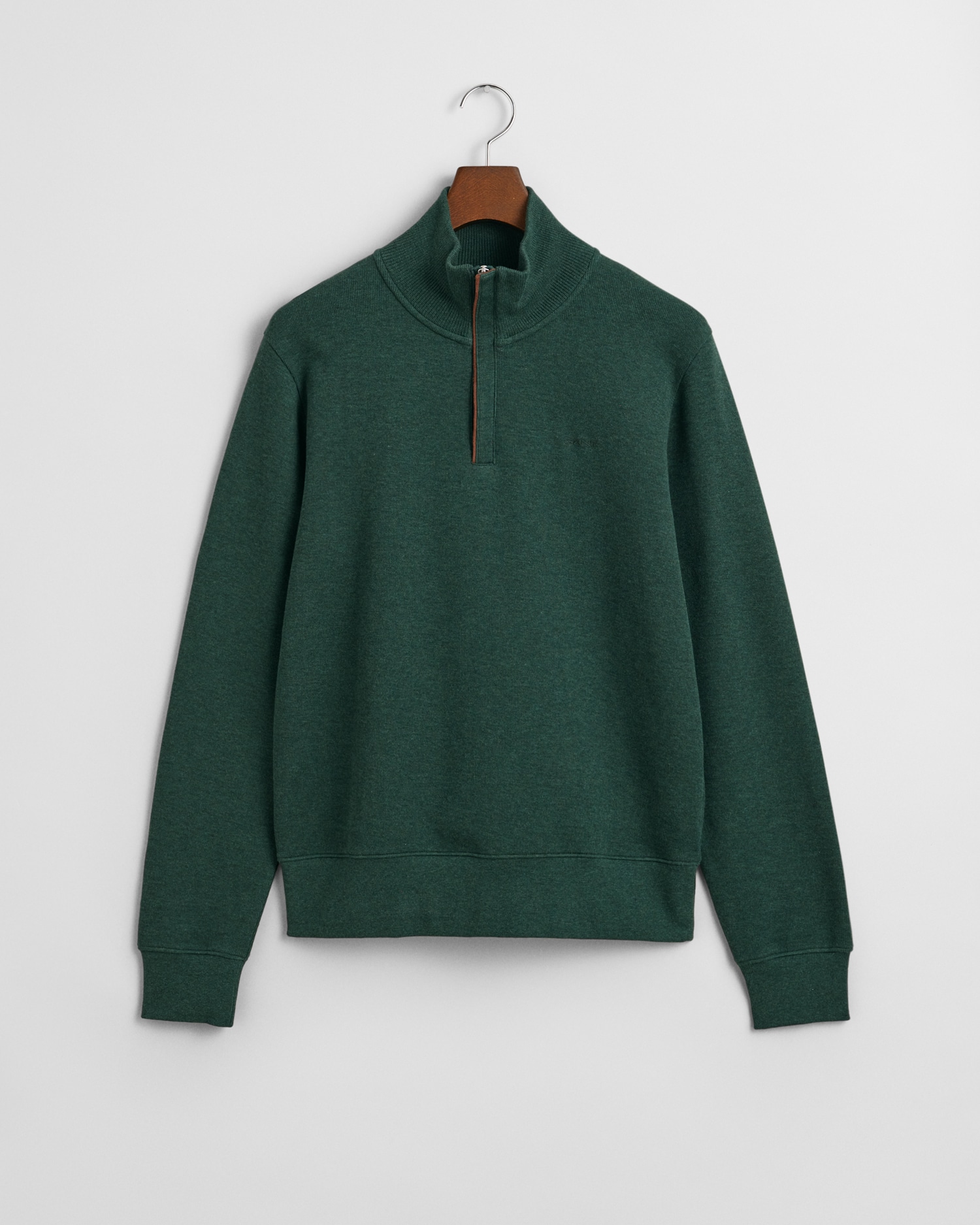 A dark green quarter-zip pullover with a stand-up collar, long sleeves, ribbed cuffs, and hem, displayed on a hanger against a plain white background.