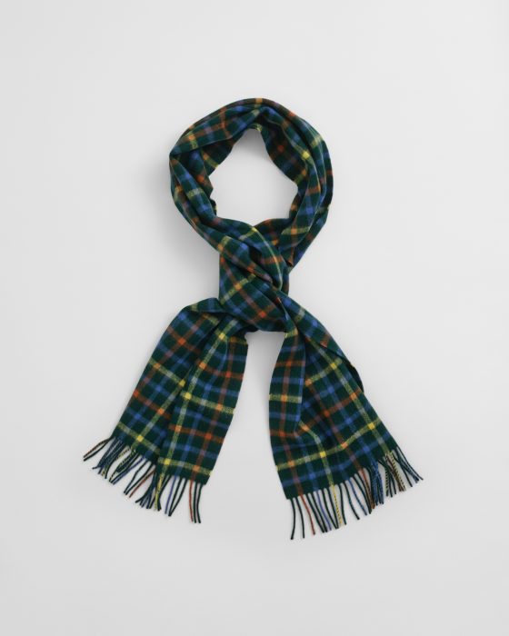 A wool scarf with a colorful plaid pattern featuring green, blue, orange, and yellow tones, arranged on a white background with the ends spread out and fringes visible.