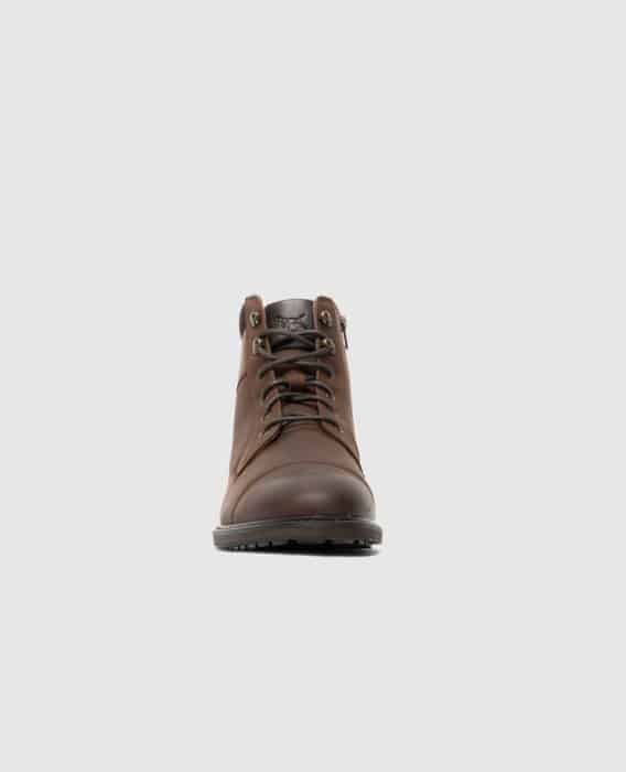 A brown leather lace-up boot is shown from the front against a plain light gray background.