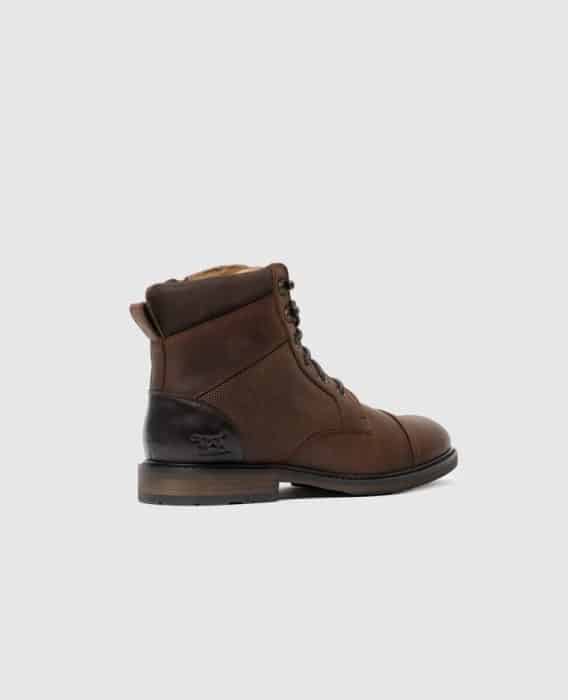 A single brown leather lace-up boot with a black heel patch, wool lining, and textured side panels, shown in a side profile view against a plain light gray background.