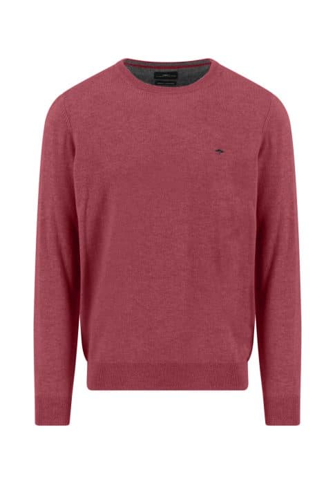 A plain, long-sleeved, crew neck sweater in a muted red color with a small, dark embroidered logo on the left chest. The sweater has ribbed cuffs, hem, and neckline.