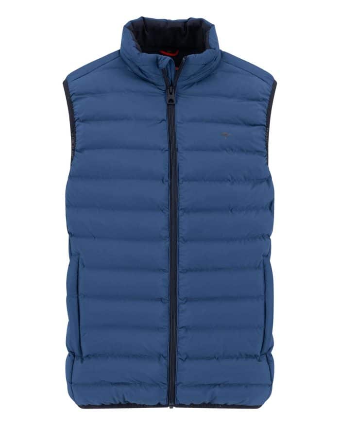 A blue, sleeveless puffer vest with horizontal quilting, front zipper closure, and two side pockets. The vest has a high collar and a subtle logo on the left chest.