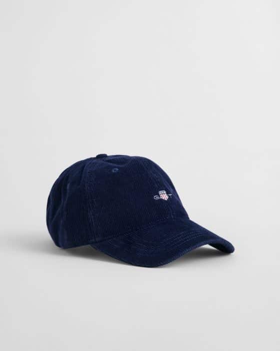 A navy blue corduroy baseball cap with a small embroidered logo on the front, displayed on a plain white background.