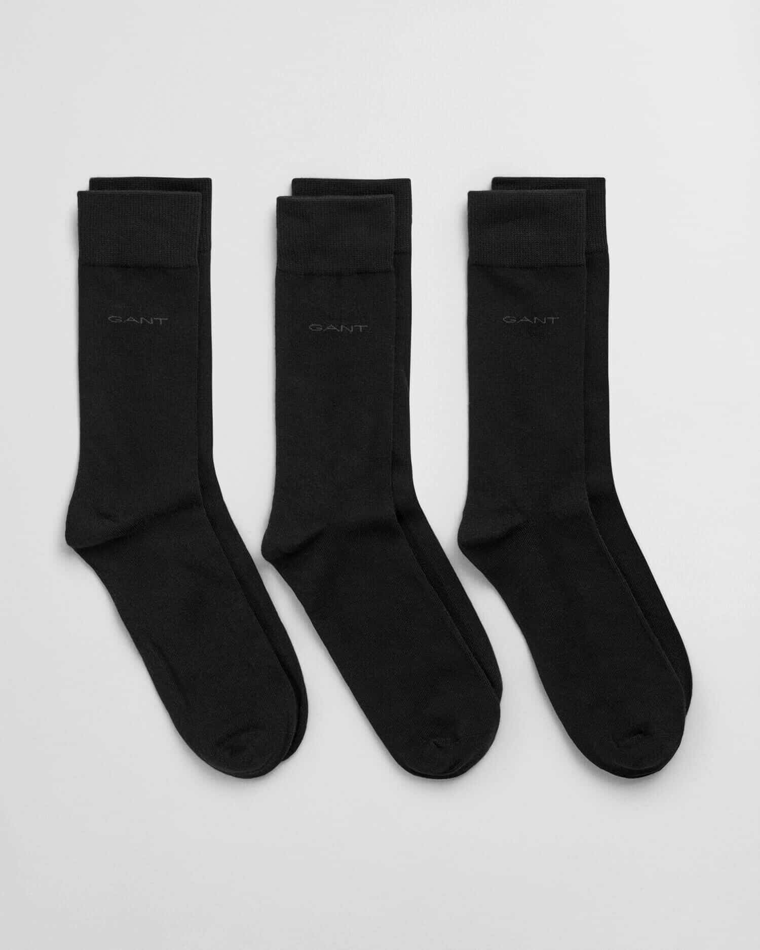 Three pairs of black crew socks are laid side by side on a light background. Each sock has a subtle GANT logo near the top.