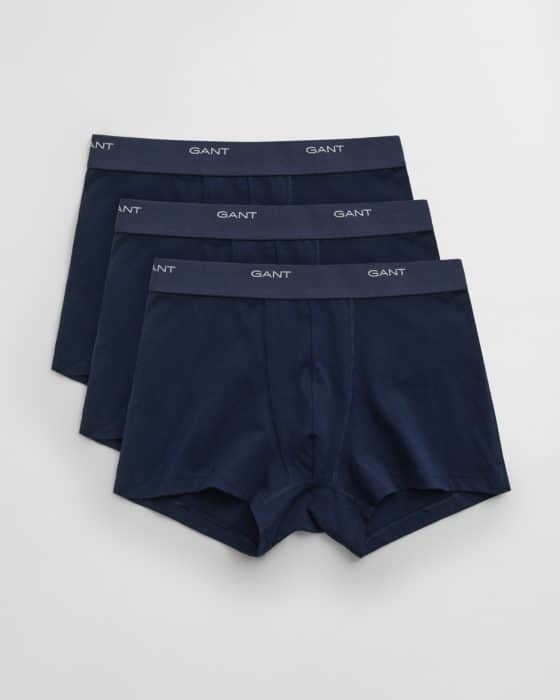 Three pairs of navy blue mens boxer briefs with elastic waistbands featuring the brand name GANT in white text, arranged in a slightly overlapping, fanned-out pattern on a white background.