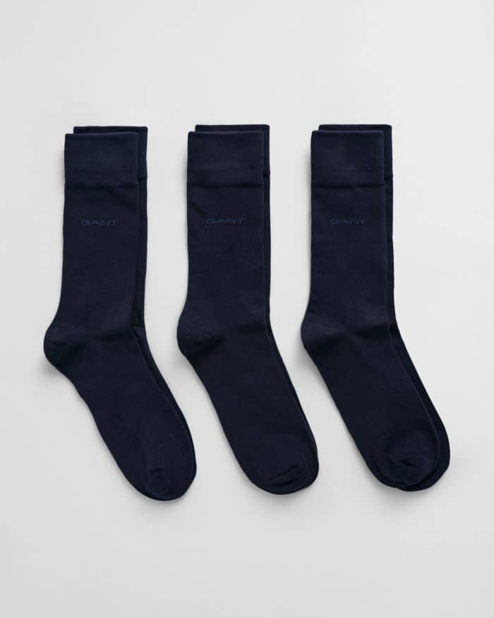 Three pairs of neatly folded dark navy socks are laid side by side on a light gray background. Each sock has a subtle GANT logo near the top.