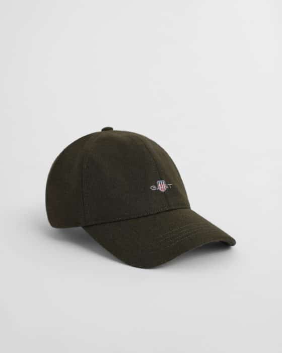 A dark olive green baseball cap with a small, embroidered logo featuring a shield and letters on the front, shown against a plain white background.