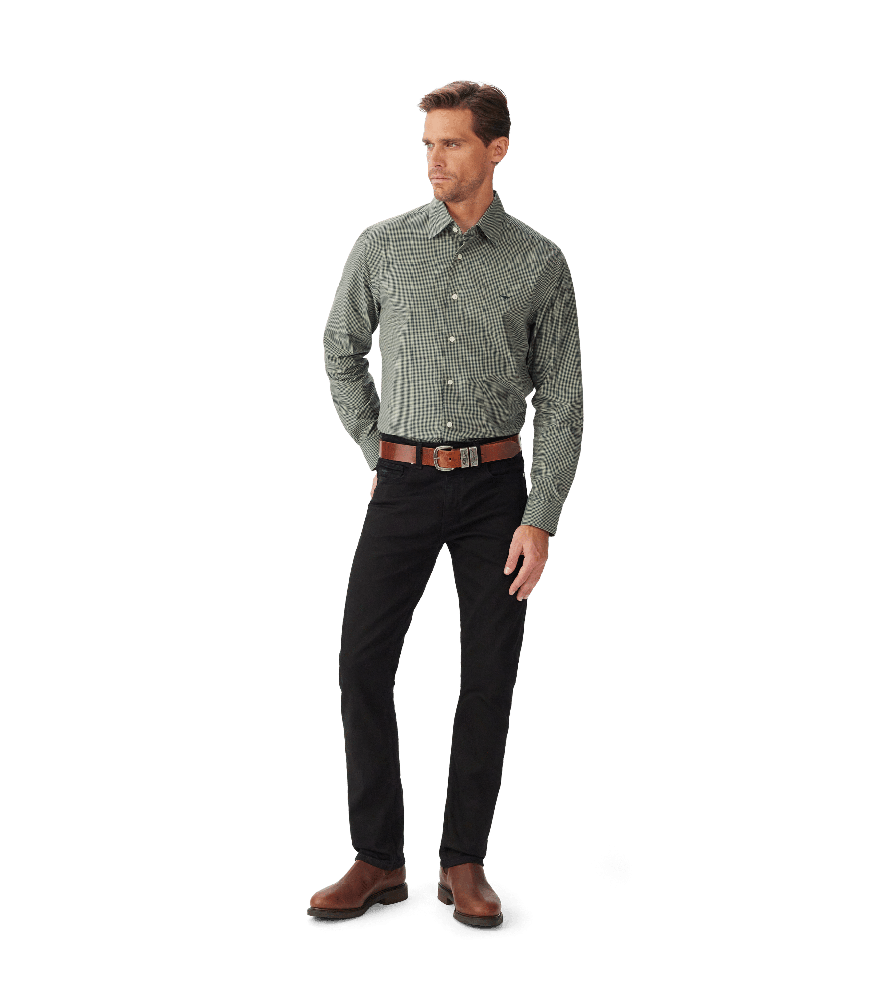 A man wearing a light green button-up shirt, black pants, a brown belt with a large buckle, and brown boots stands against a plain white background.
