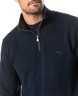 A man wearing a dark navy quarter-zip pullover with a small embroidered animal logo on the chest, shown from shoulders to mouth against a white background.