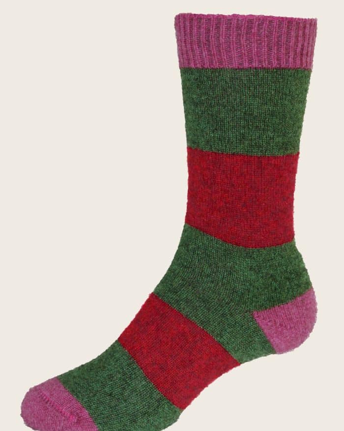 A single sock featuring wide horizontal stripes in green and red, with a pink cuff, heel, and toe against a plain light background.