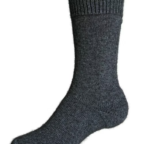 A single dark gray, ribbed wool sock is shown on a foot, photographed from the side on a plain white background.