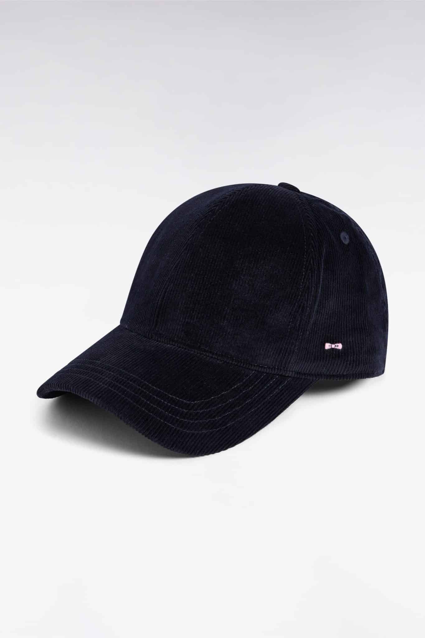 A navy blue corduroy baseball cap with a curved brim, displayed against a plain white background. There is a small metallic detail on the side of the cap.