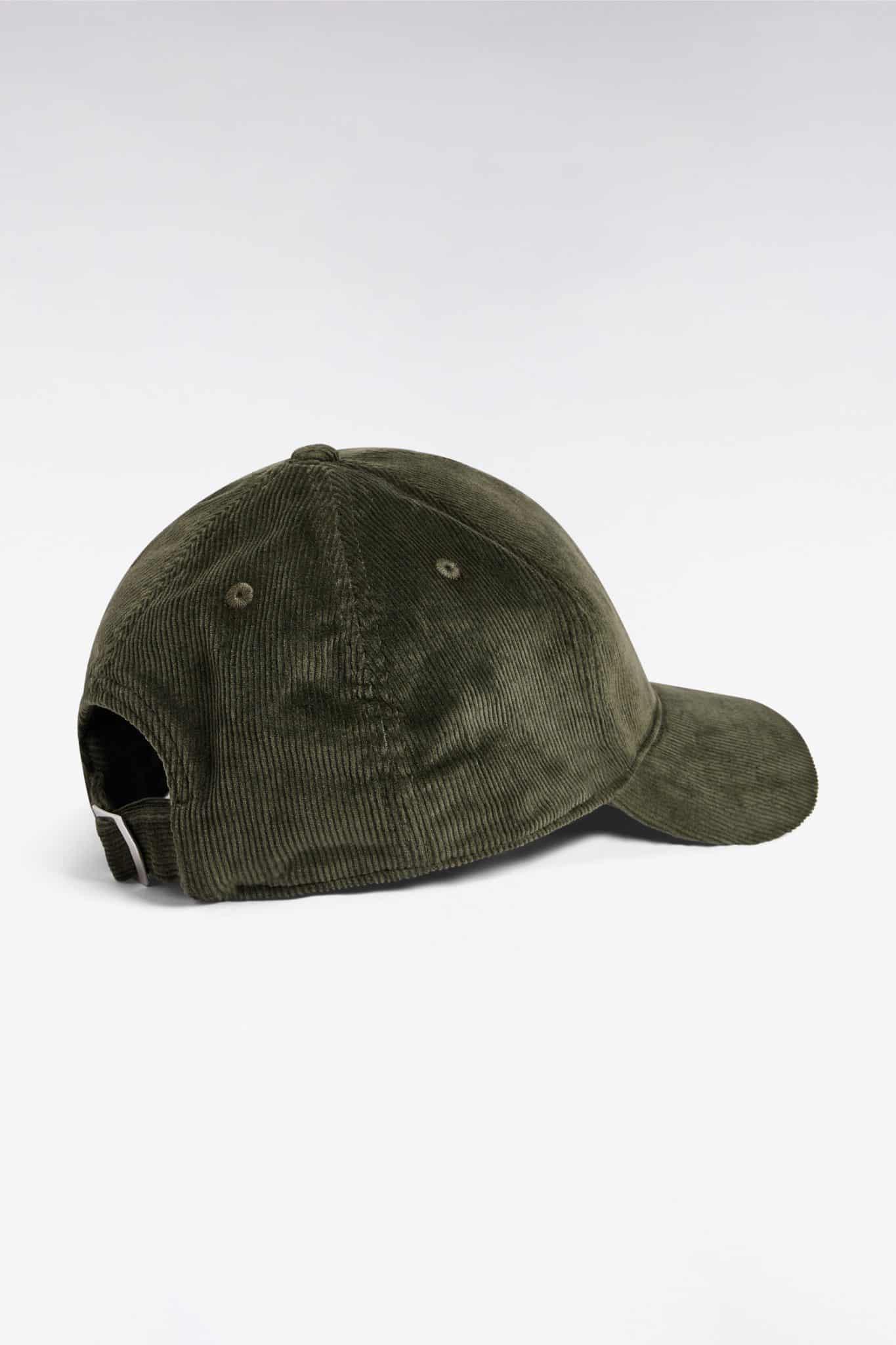A dark green corduroy baseball cap is shown from the back, featuring a curved brim and an adjustable strap with a metal buckle. The background is plain white.