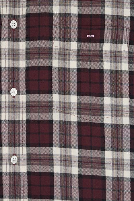 Close-up of a maroon, black, white, and gray plaid shirt with white buttons and a front pocket. The fabric features a checkered pattern and a small stitched detail above the pocket.