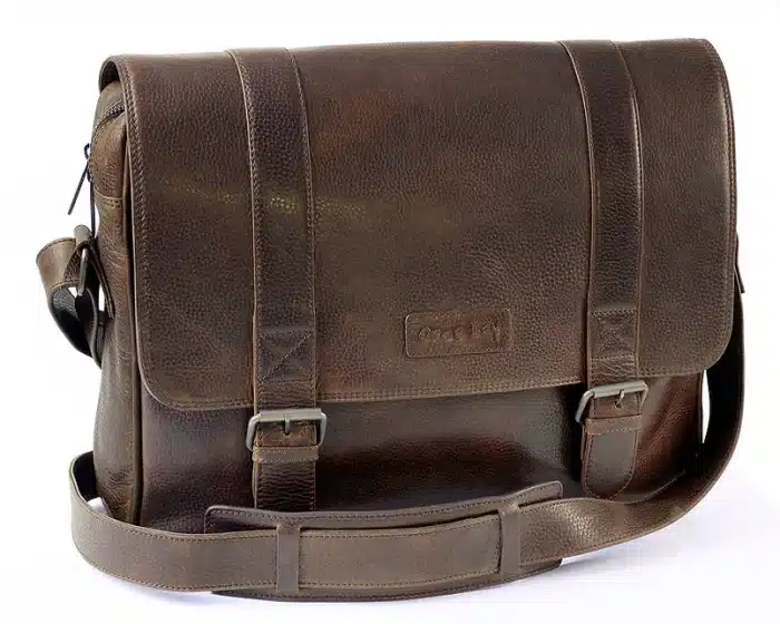 A dark brown leather messenger bag with a flap cover, two buckle straps, and an adjustable shoulder strap, placed on a white background.
