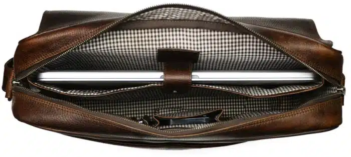 A brown leather bag with a silver metal object inside.