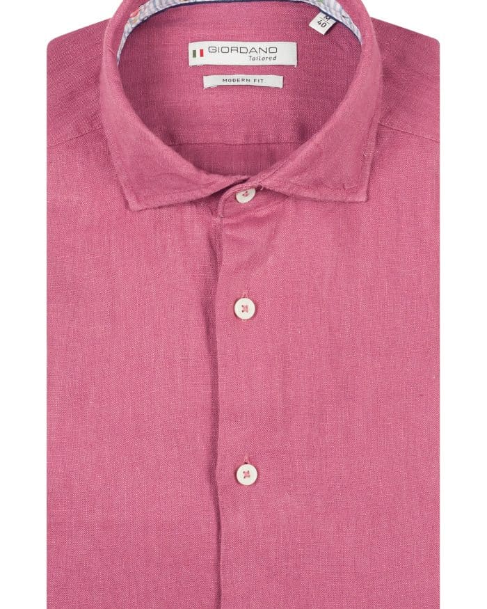 A neatly folded long-sleeved, button-up shirt in a solid mauve colour with white buttons and a patterned inner collar, labelled Giordano Tailored Modern Fit.