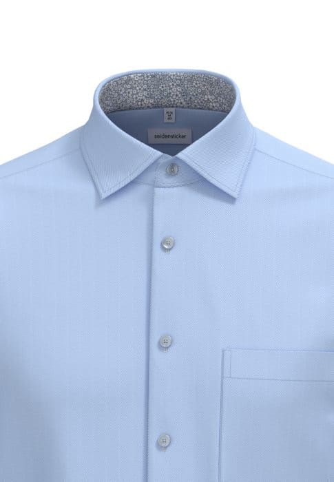 Light blue dress shirt with a pointed collar, featuring a subtle textured pattern. The inside of the collar has a contrasting grey floral lining. The shirt has a front pocket and four white buttons.