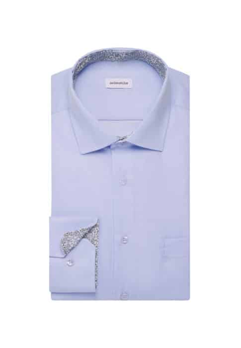 A neatly folded light blue dress shirt with a small floral pattern on the inside collar and cuffs, displayed on a white background.