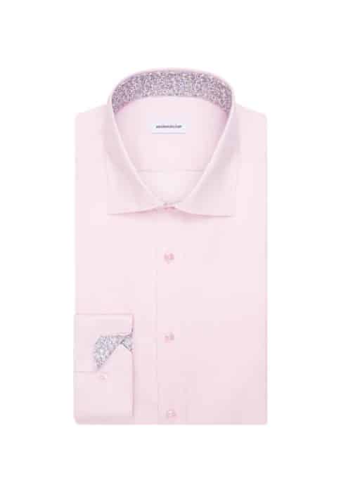 A neatly folded light pink dress shirt with floral-patterned fabric visible inside the collar and cuffs, displayed on a white background.