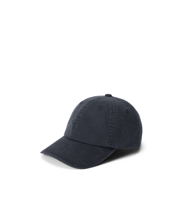 A plain, dark navy blue baseball cap with visible stitching is shown on a light grey background. The cap has a curved peak and a soft, structured crown.