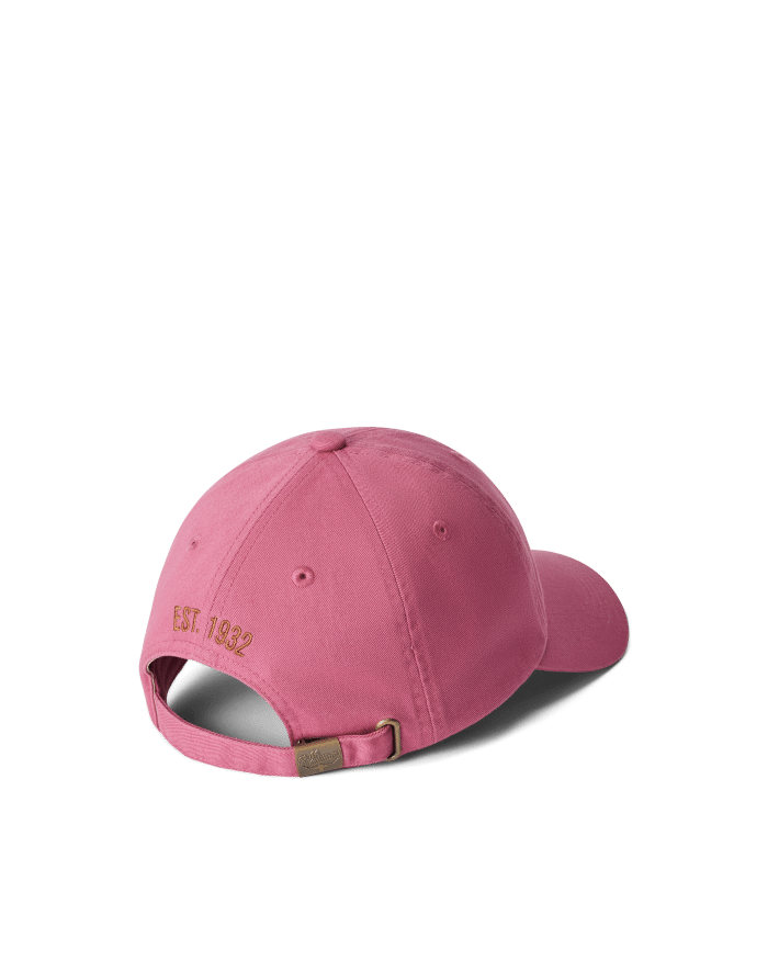 A pink baseball cap viewed from the back, featuring an adjustable strap with a metal buckle and the text E.S.T. 1832 embroidered in gold above the opening.