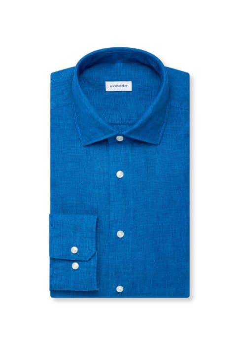 A neatly folded, long-sleeve, button-up shirt in vibrant blue linen, featuring a classic collar and white buttons, displayed against a plain white background.