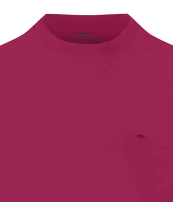 A close-up of a plain magenta T-shirt with a small embroidered tree logo and the brand name Fynch-Hatton visible inside the collar.