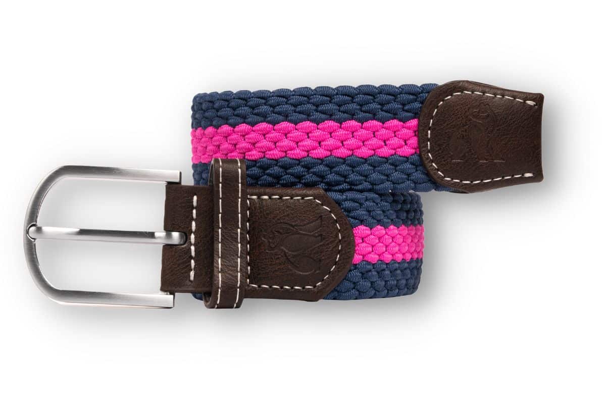 A woven belt with navy and pink stripes, featuring brown leather ends and a silver buckle. The leather has visible stitching and an embossed penguin logo.