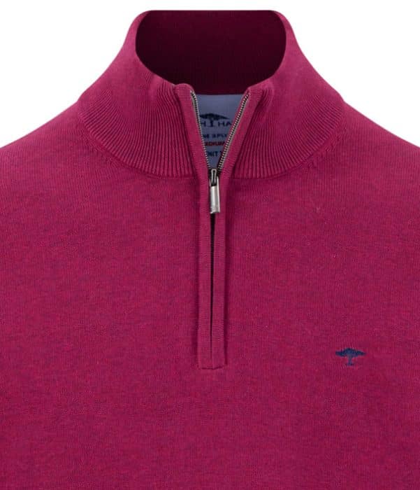 Close-up of a maroon quarter-zip jumper with a standing collar and a small blue embroidered logo on the left chest. The zip is partially open, revealing the inside label.