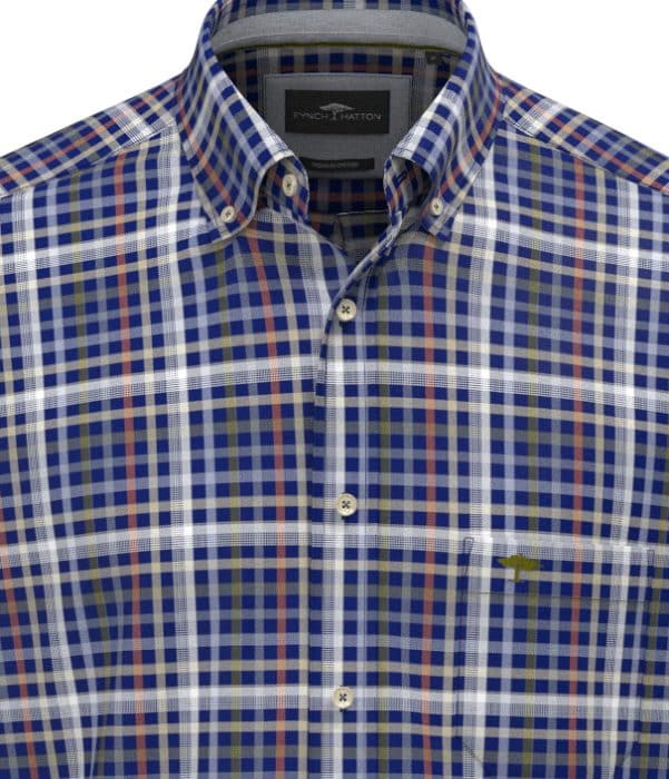 A close-up of a button-up, long-sleeve shirt with a blue, white, brown, and green check pattern. The shirt features a button-down collar and a subtle embroidered logo on the chest.