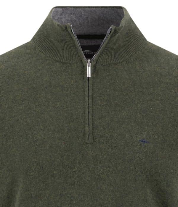 Close-up of a green quarter-zip jumper with a ribbed collar. The zip is partially open, revealing a grey inner lining. A small logo is stitched on the left chest.