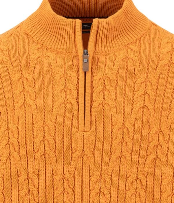 Close-up of an orange cable-knit jumper with a ribbed mock neck and a half-zip fastening.