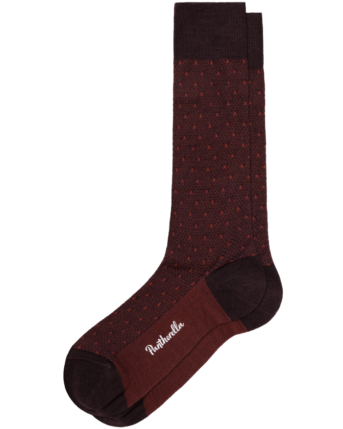 A single maroon sock with small red polka dots, dark maroon heel and toe, and the word Pantherella written in white on the sole.