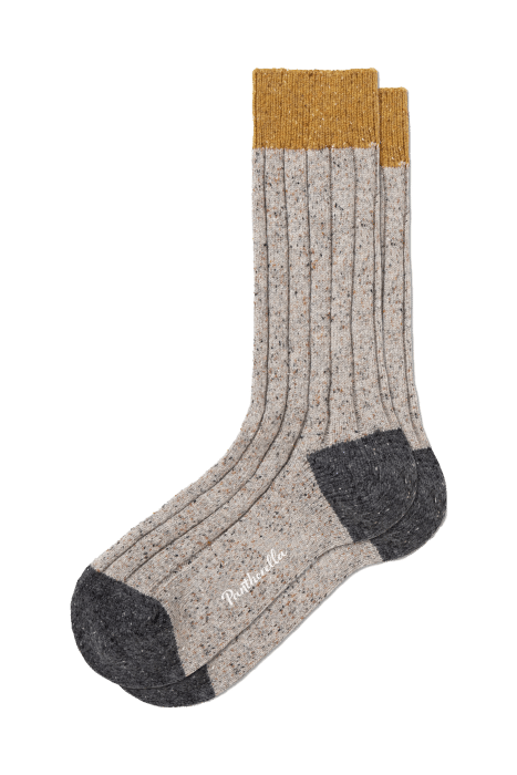 A pair of speckled grey ribbed socks with mustard yellow cuffs, dark grey toes and heels, and white text near the toes, displayed on a plain white background.
