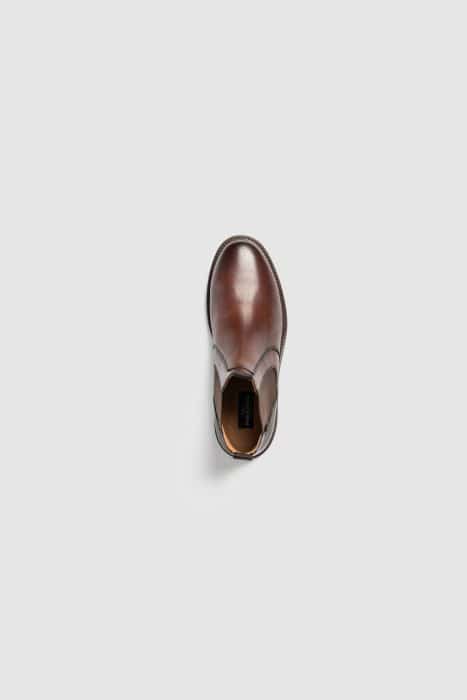 A single brown leather Chelsea boot is shown from above on a plain light grey background.