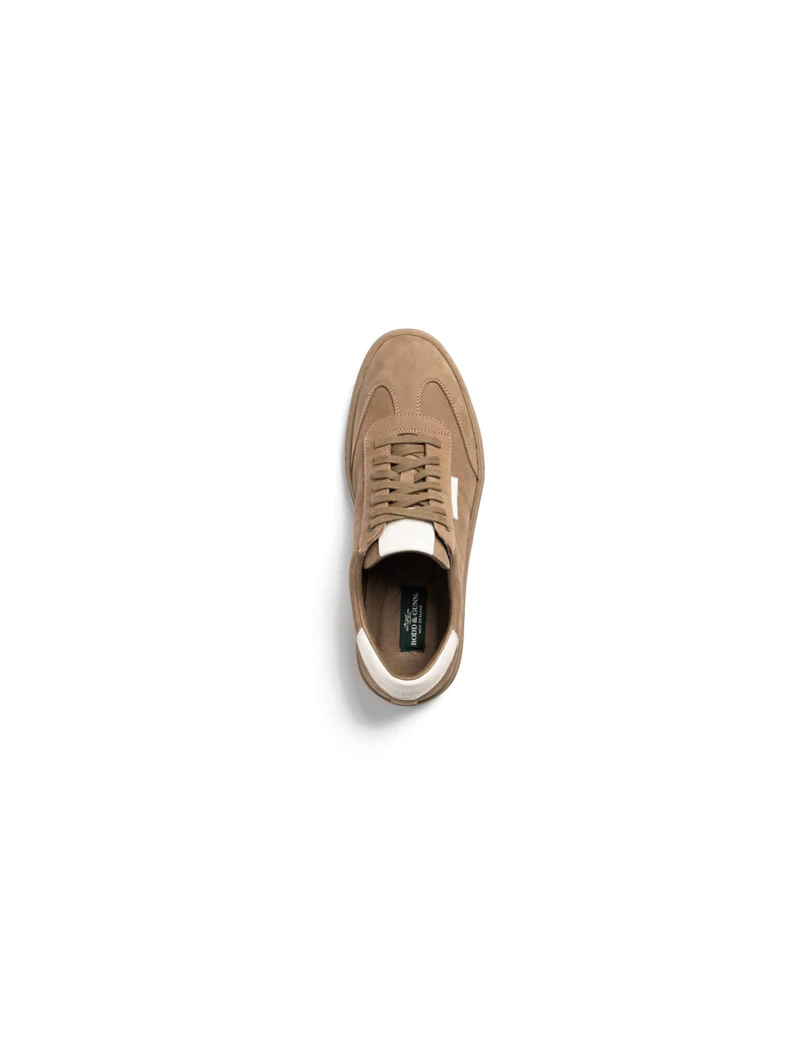 A single tan suede trainer with white accents, viewed from above, centred on a white background.