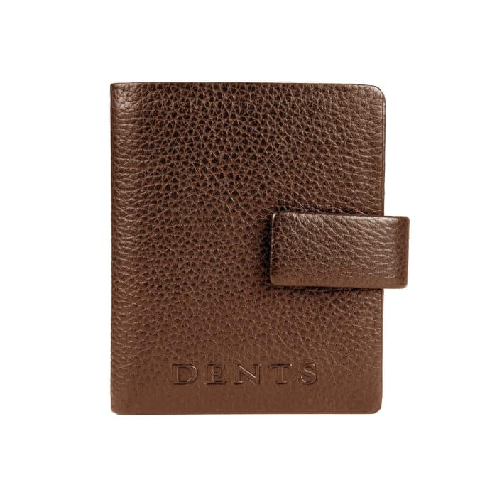 Brown leather passport holder with a press-stud fastening and the Dents logo embossed at the bottom.