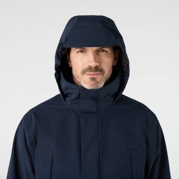 A man wearing a navy blue hooded jumper.
