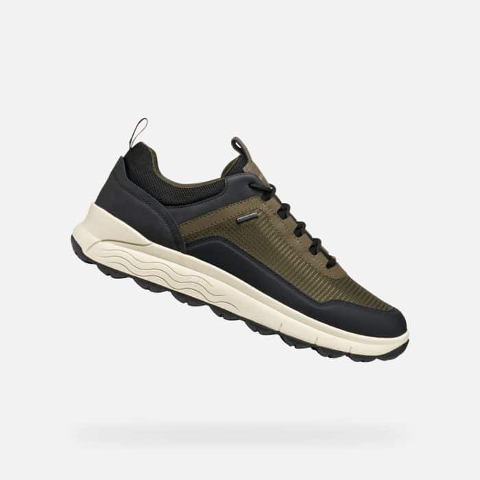 Olive green and black low-top trainer with a thick off-white midsole and a black lugged rubber sole.